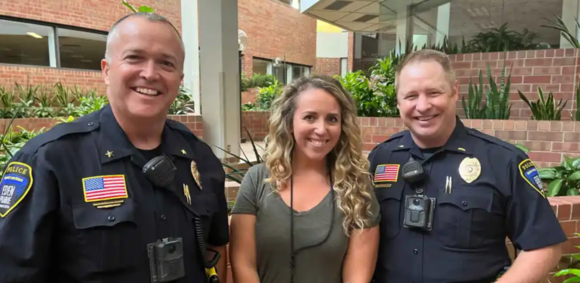 Police officers and social worker smiling