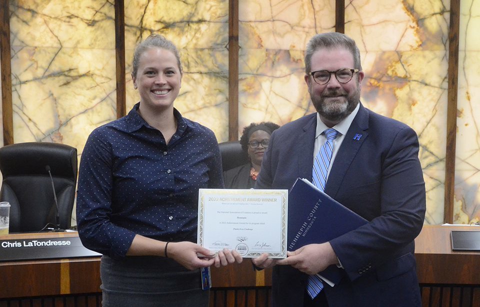 Chris handing employee the recognition from NACo