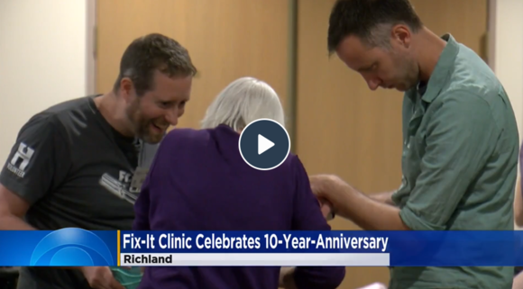 People huddled over smiling at each other