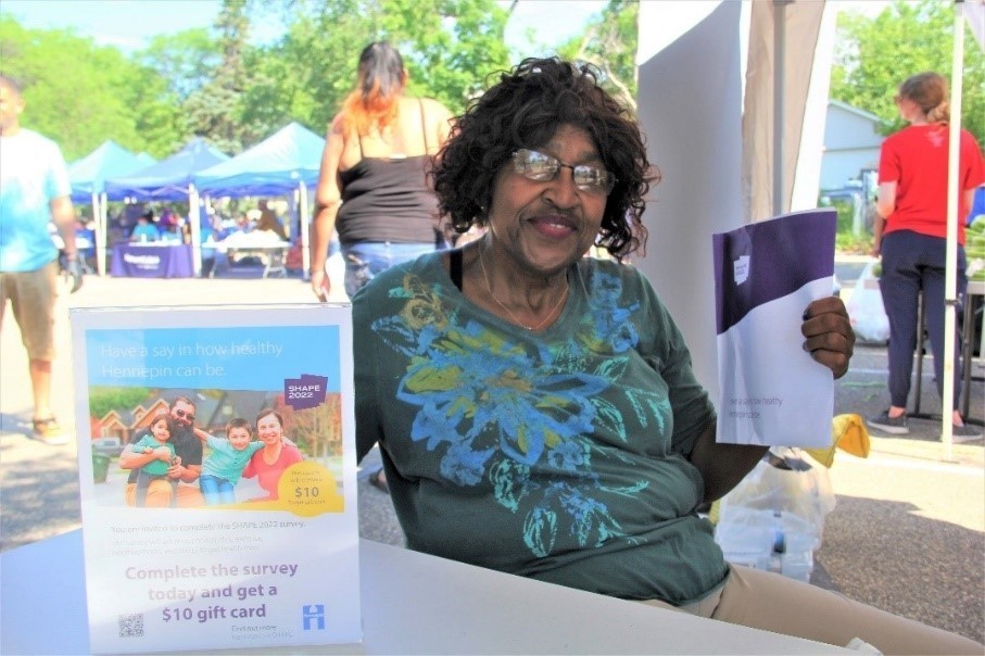 Woman smiling sitting at a table with papers