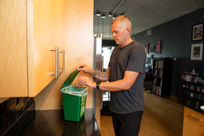 Man putting compost in countertop bin