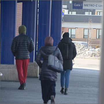 Photo: Staff members walking into bus shelter