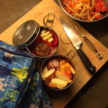 Image of plastic-free lunch with metal containers, water bottle, and reusable snack bags