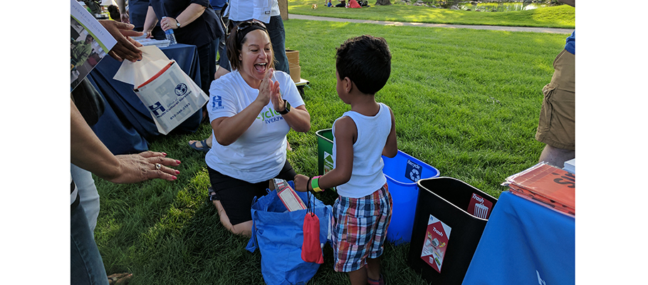 Community Recycling Ambassador teaching young child about recycling