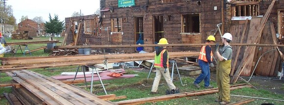 People deconstructing a building