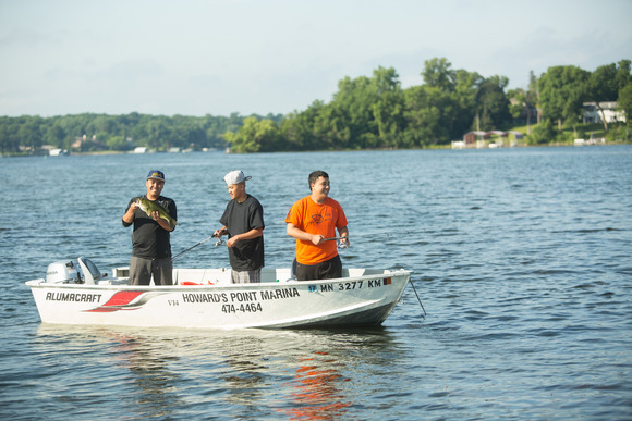 Three men in a fishing boat on Lake Minnetonka