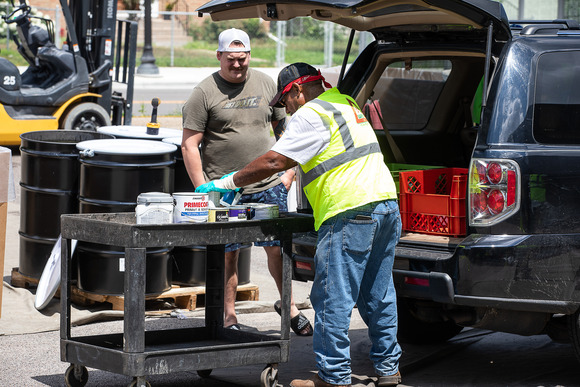 Two men unloading a car at a hazardous waste collection event