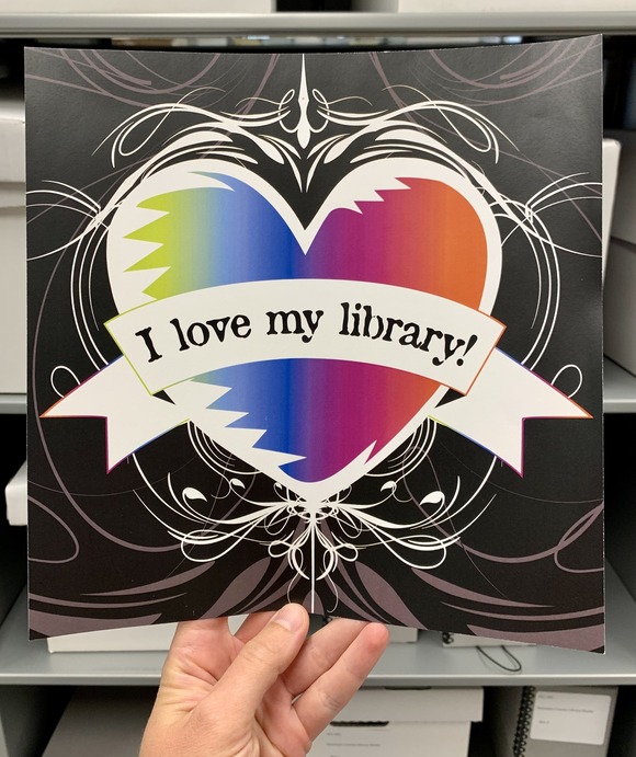 Heart photo in hand reads "I love my library" 