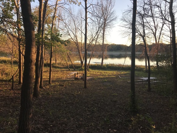 View of the lake through the trees at sunset at Camp Edenwood