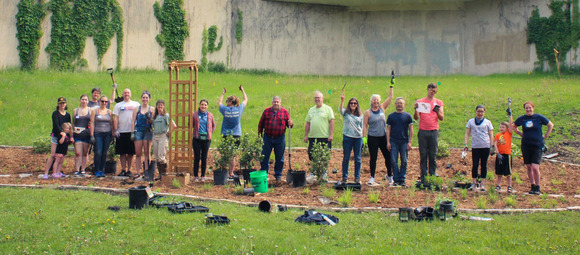 A group of Water Stewards work together on a rain garden
