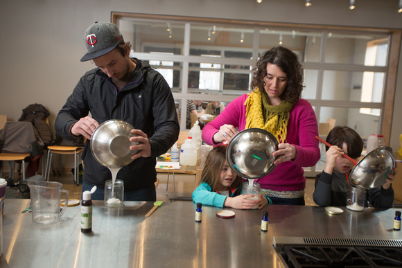Two adults and two children at a cooking class