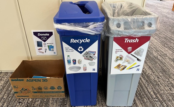 Trash, recycling, and donate bins in front of lockers