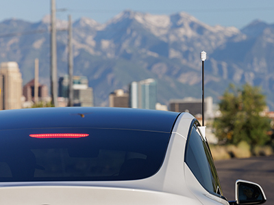 Sensor used for heat mapping on a car driving in a city with mountains in background