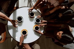 Coffee overhead shot of cups and hands on a round table