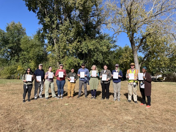 Participants holding tree drawings