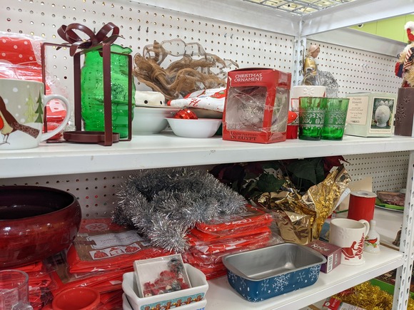 Seasonal dishes and decorations on a shelf at a thrift store