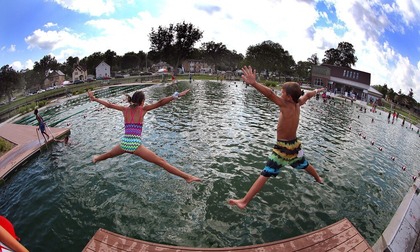 kids jumping into a lake