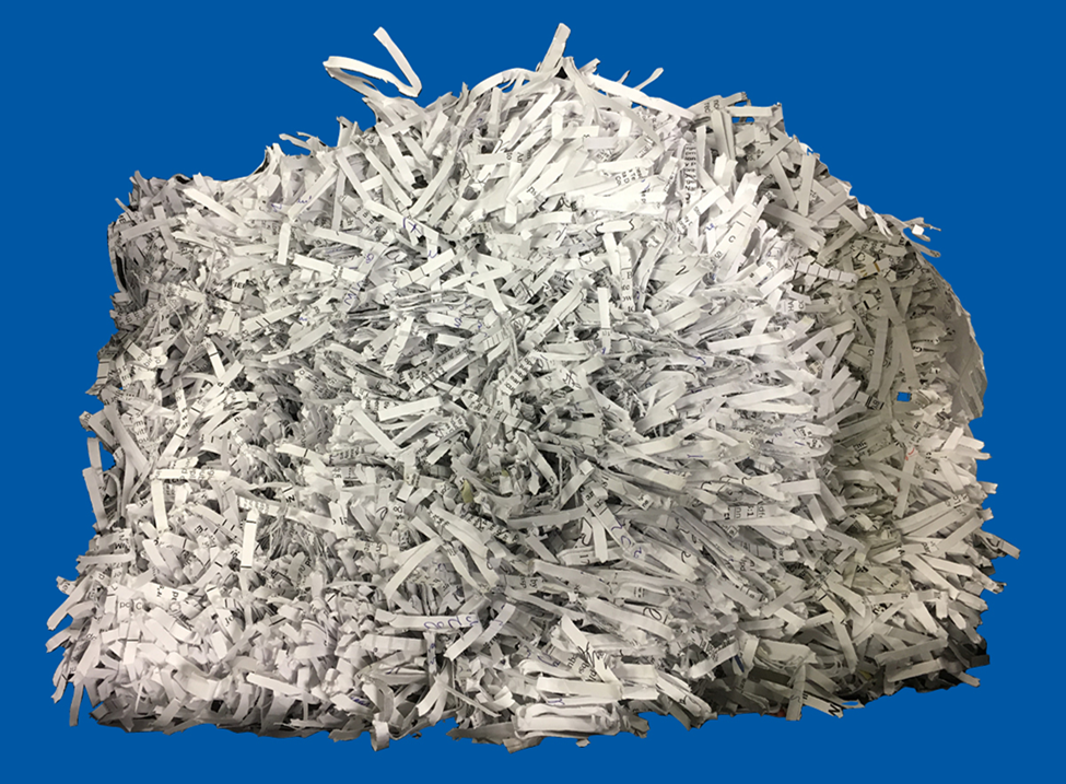 Pile of shredded white office paper on blue background