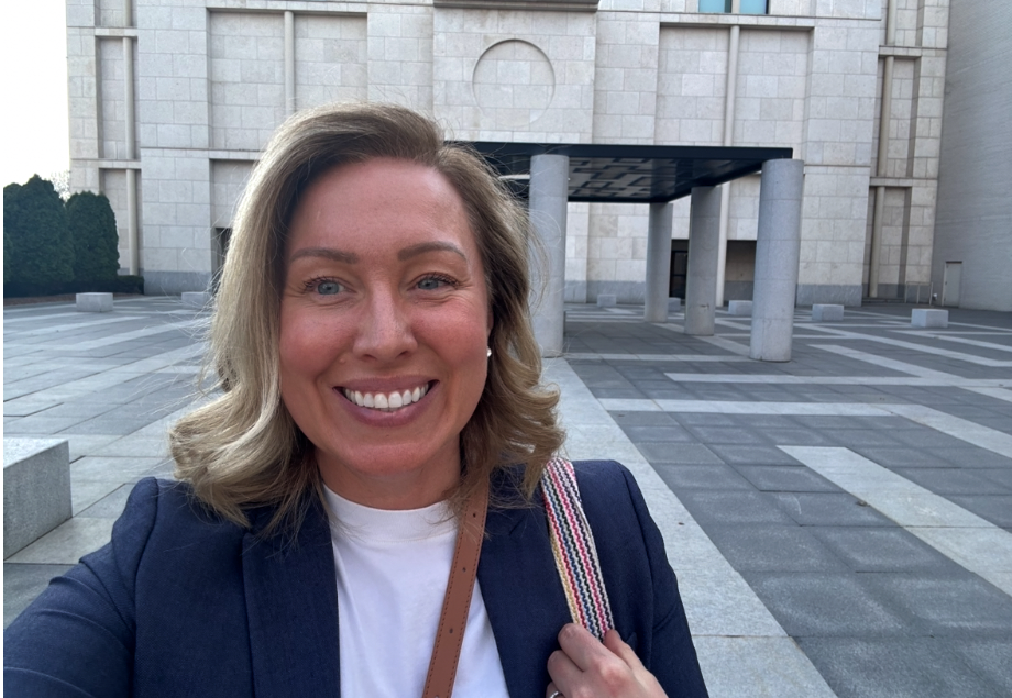 Heather smiles in a selfie taken at the Mia courtyard.