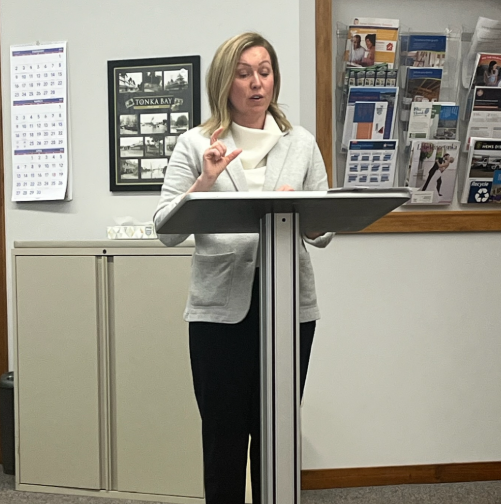 Heather stands at a podium while speaking to Tonka Bay City Council.