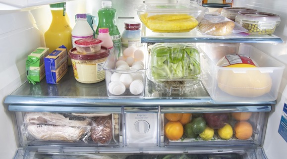 View inside of a fridge stocked with a variety of food