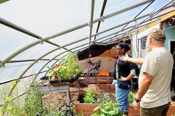 Jose Luis and Commissioner Conley in a green house at Tamales y Bicicletas