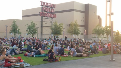 Community members watch a movie near Target Field.