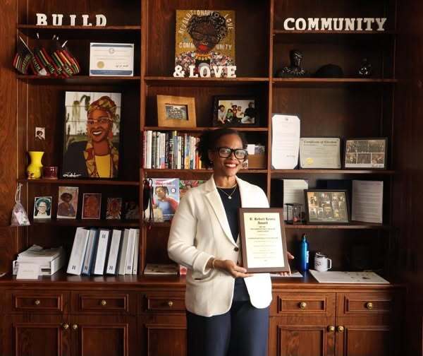 Commissioner Conley holding her B. Robert Lewis award