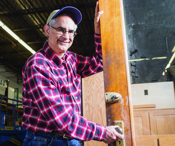 person holding an antique door