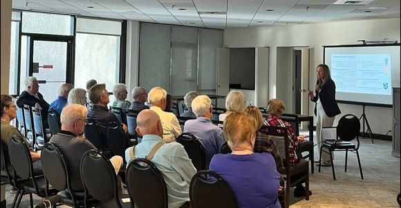 Cmsr. Edelson presents to a group of constituents in a community room at the Point of France condominium complex.