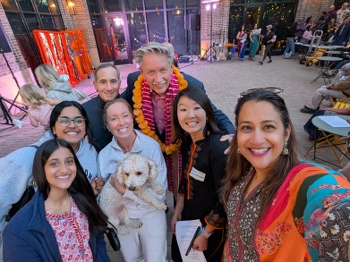 Heather smiles with her dog and husband, Edina Mayor James Hovland, neighbors, and friends at a square within 50th and France.