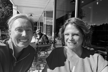 Heather takes a selfie outside of her a Rep. Youakim; both are smiling on a sunny patio. There is a black and white filter applied.