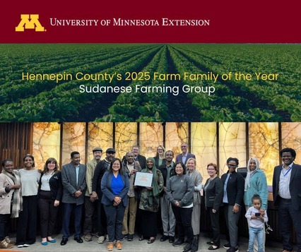 Commissioners pose with members of the Sudanese Farming Group in the board room.