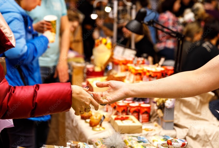 Craft fair and market photo of people exchanging goods and services. 