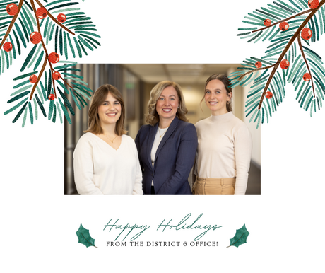 A holiday card showing Commissioner Edelson smiling with her two staff on either side, smiling as well. It says "Happy Holidays."