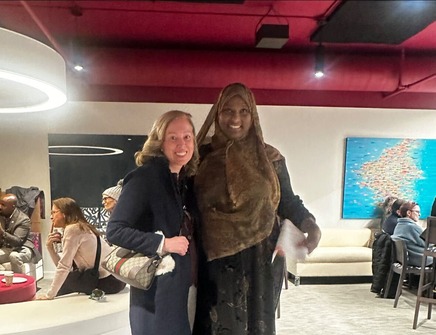 Heather poses with neighbors at the Know Your Neighbor event, smiling.