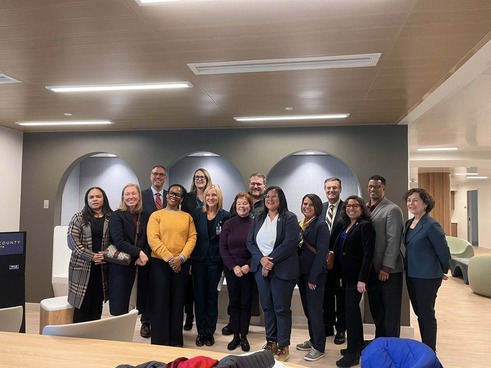 Commissioners pose with staff in the lobby of the newly-opened youth stabilization center.