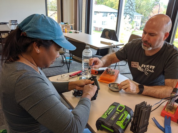 Fix-It Clinic volunteer and participant working on a repair