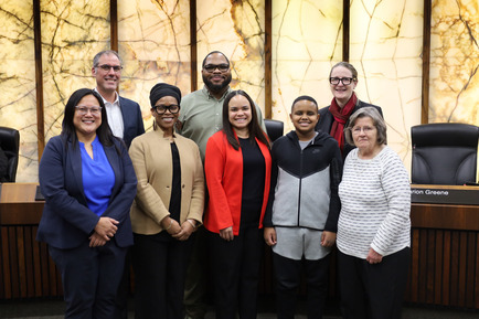 Commissioners pose for a congratulatory photo with Sara Hollie.
