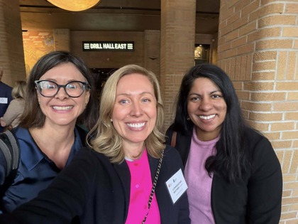 Heather takes a selfie and smiles in the middle of two other women at the Downtown Mpls event.