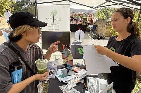 EcoAlpha youth ambassador talking to someone at a community event