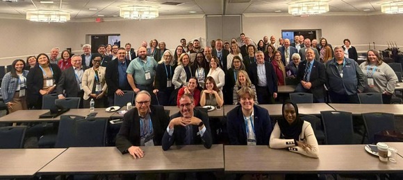 A photo of all Minnesota attendees of the National Association of Counties in Washington D.C. It's in a large hotel conference room.