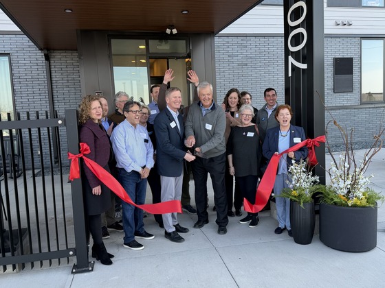 Commissioner Goettel with leaders at the Rosalyn Apartments cutting a ribbon