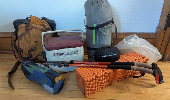 Used tent, cooler, treking poles, sleeping pad, and pack