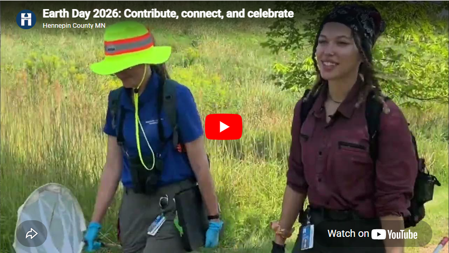 Screenshot of Earth Day video with two Hennepin County employees walking in a field