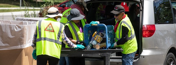 People bringing household hazardous waste to an event