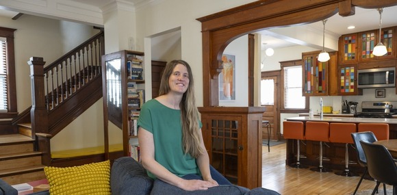Woman posing in her refurbished 1903 home