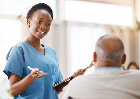 Female in scrubs with male patient