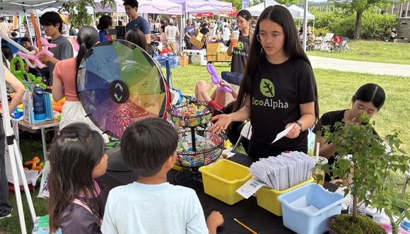 EcoAlpha participant teaching young kids at an event