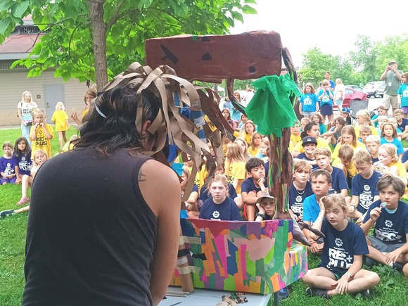 People giving a puppet show to an audience